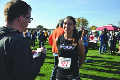 Sequim Gazette Editor Michael Dashiell interviews a Sequim High School cross country runner at the state 2A championships in Pasco in 2015. (Photo courtesy of Michael Dashiell)