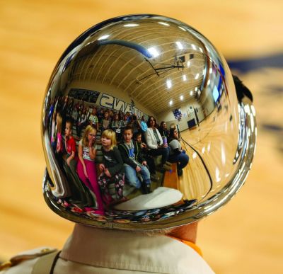 The faces of tomorrow’s leaders were reflected in the helmet of American Legion Color Guard member Jim Schaffer during the Veteran’s Day Program that was held at the Leola School. (Nov. 18, 2021)  (Jeremy Cox | McPherson County Herald, Leola, South Dakota)