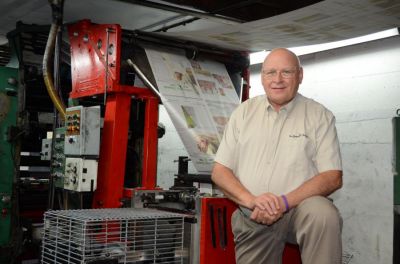 John M. Galer stands with the presses at The Journal-News in Hillsboro, Illinois. Galer, NNA past president, Mailers Technical Advisory Committee (MTAC) representative and former publisher, The Hillsboro Journal Inc., will be honored with the James O. Amos Award during the NNA Foundation&rsquo;s 140th Annual Convention & Trade Show in Detroit on September 18, 2026.