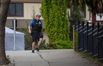 NEWS — Wenatchee police officer Brian Hewitt, shot in the leg, runs for cover near the Living Hope Community Church on the corner of Chelan and Palouse Streets Saturday morning, May 7, 2022. He and two other officers discharged their weapons, killing Alexander J. White, 36, East Wenatchee, in the altercation who police say was shooting at the church. (Pub Aux Photo Contest judges also gave a nod to Seabrook s feature photo entry capturing the delight and curiosity of local fouth graders on a field trip through a skylight.) (Don Seabrook | The Wenatchee (Washington) World)